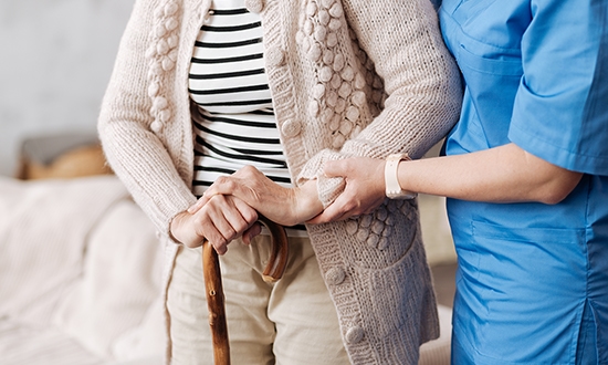 Carer helping patient with dementia